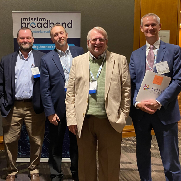 Matt Chandler, Trevor Gordon, and Brian Thibeau with the president of the Schools, Health & Libraries Broadband Coalition.